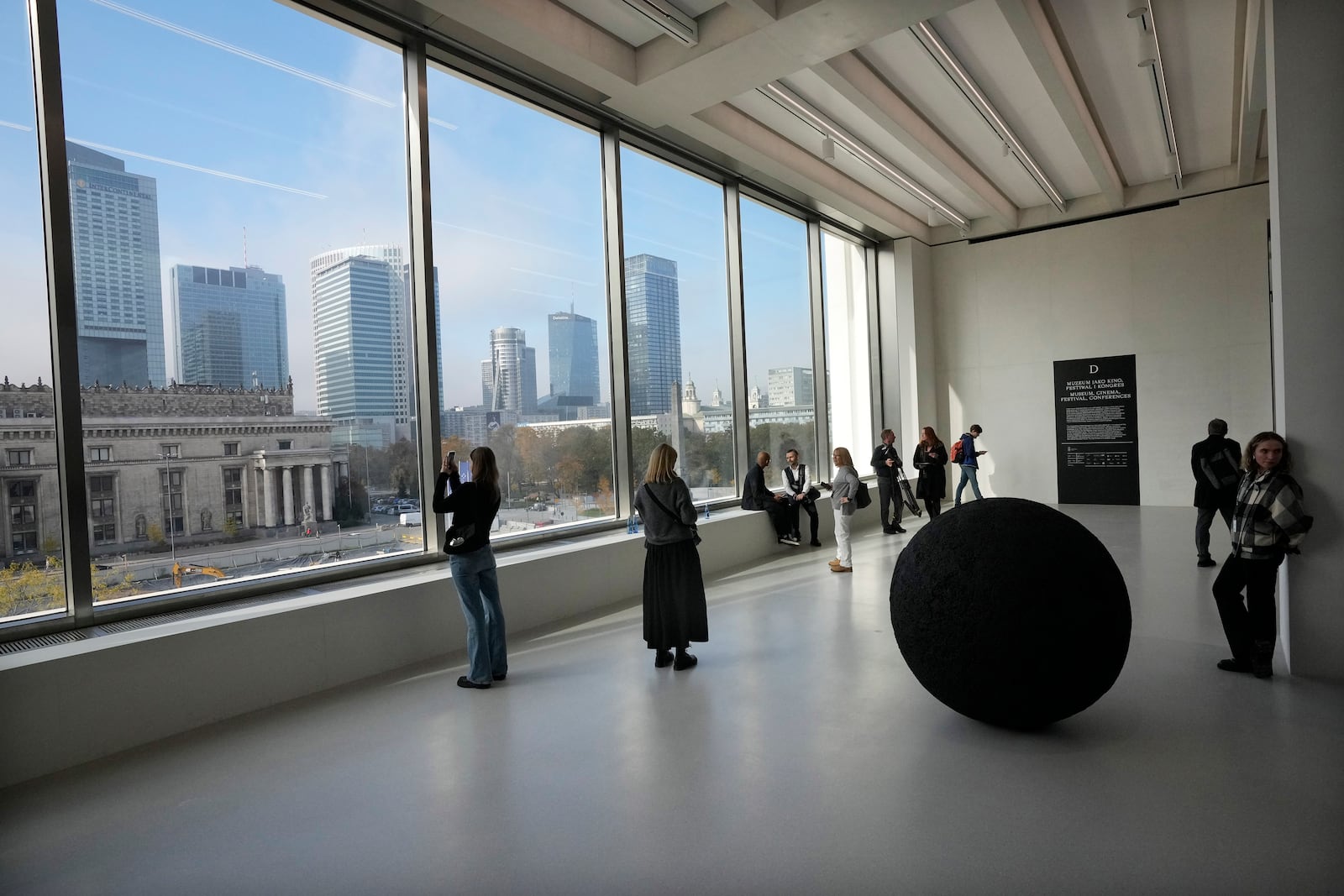 People look out of the window of the Museum of Modern Art in Warsaw, Poland, on Thursday Oct. 24, 2024. (AP Photo/Czarek Sokolowski)