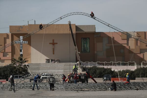 Workers begin the installation of a temporary shelter for possible deportees from the United States, in Ciudad Juarez, Mexico, Wednesday, Jan. 22, 2025. (AP Photo/Christian Chavez)