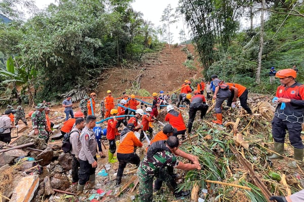 Rescuers search for victims at the site of a landslide in Pekalongan, Central Java, Indonesia, Thursday, Jan. 23, 2025. (AP Photo/Janaki DM)