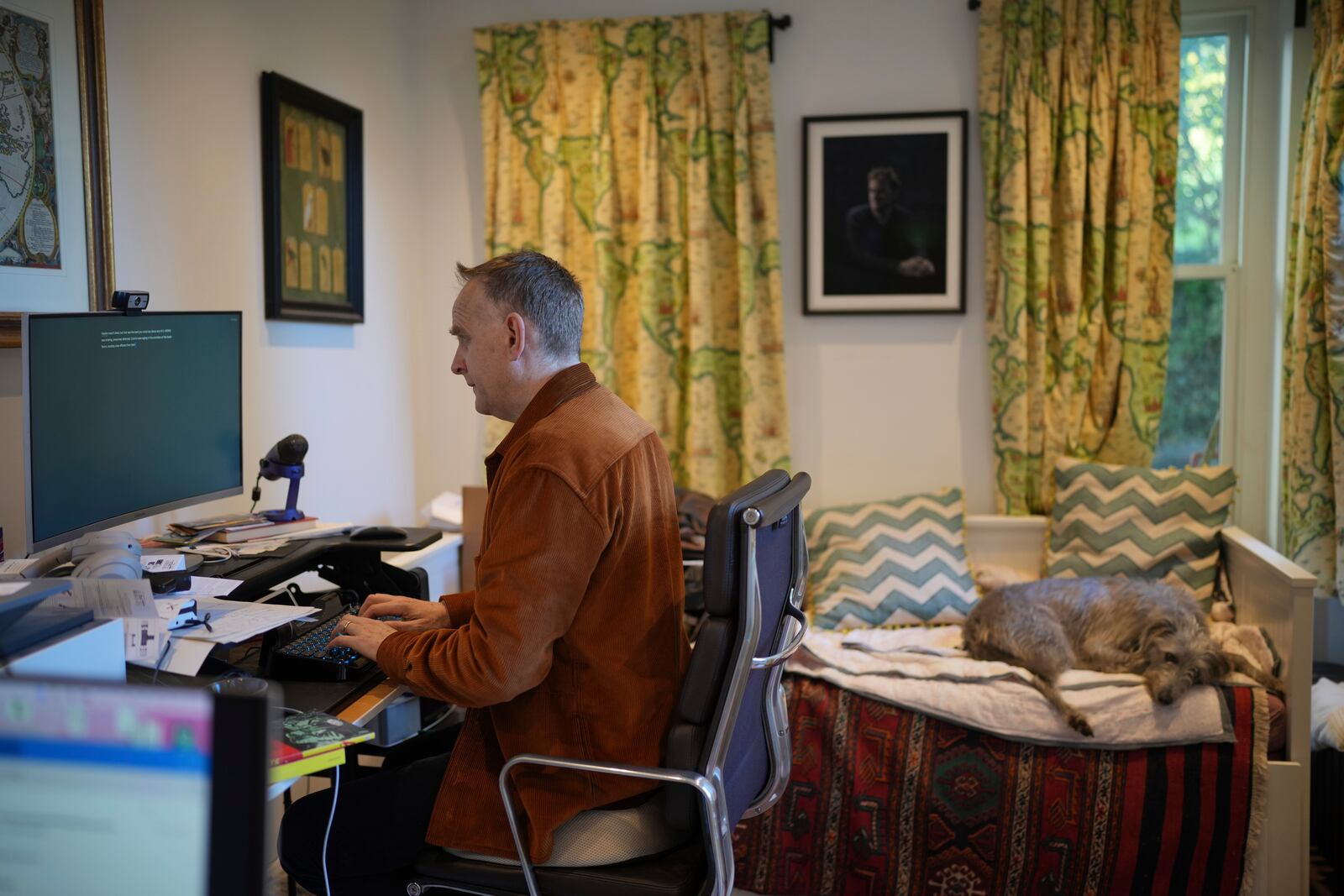 British author Nick Harkaway, son of John le Carre, works, at his home, in London, Thursday, Oct. 24, 2024. (AP Photo/Kin Cheung)