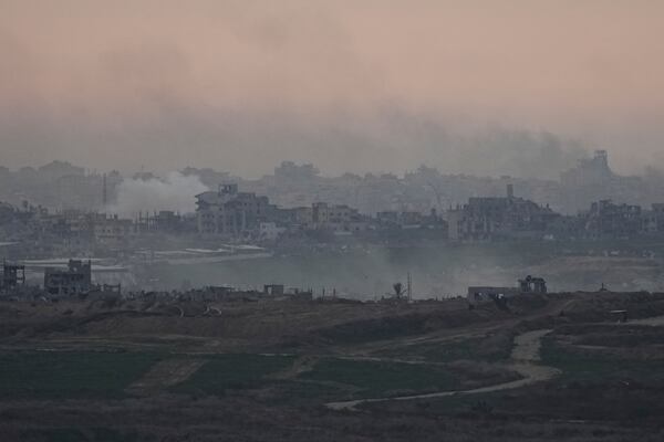 Destroyed buildings by Israeli bombardments are seen inside the Gaza Strip from southern Israel, on Tuesday, Jan. 14, 2025. (AP Photo/Tsafrir Abayov)