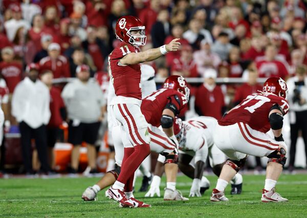 Oklahoma quarterback Jackson Arnold (11) gestures to his team before a play against Alabama during the second quarter of a NCAA college football game Saturday, Nov. 23, 2024, in Norman, Okla. (AP Photo/Alonzo Adams)