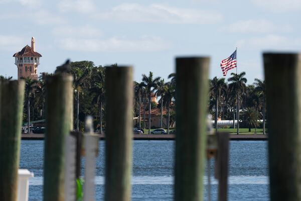 The U.S. flag is shown at the Mar-a-Lago compound in Palm Beach, Fla., while a U.S. Coast Guard boat patrols around the vicinity, Monday, Jan. 13, 2025. U.S. flags at President-elect Donald Trump's private Mar-a-Lago club are back to flying at full height. Flags are supposed to fly at half-staff through the end of January out of respect for former President Jimmy Carter, who died Dec. 29. (AP Photo/Manuel Balce Ceneta)