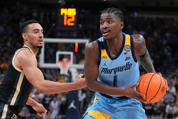 Marquette's Kam Jones tries to get past Purdue's Trey Kaufman-Renn during the first half of an NCAA college basketball game Tuesday, Nov. 19, 2024, in Milwaukee. (AP Photo/Morry Gash)