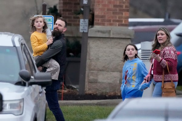 Families leave the SSMI Health Center, set up as a reunification center, following a shooting, Monday, Dec. 16, 2024 in Madison, Wis. (AP Photo/Morry Gash)