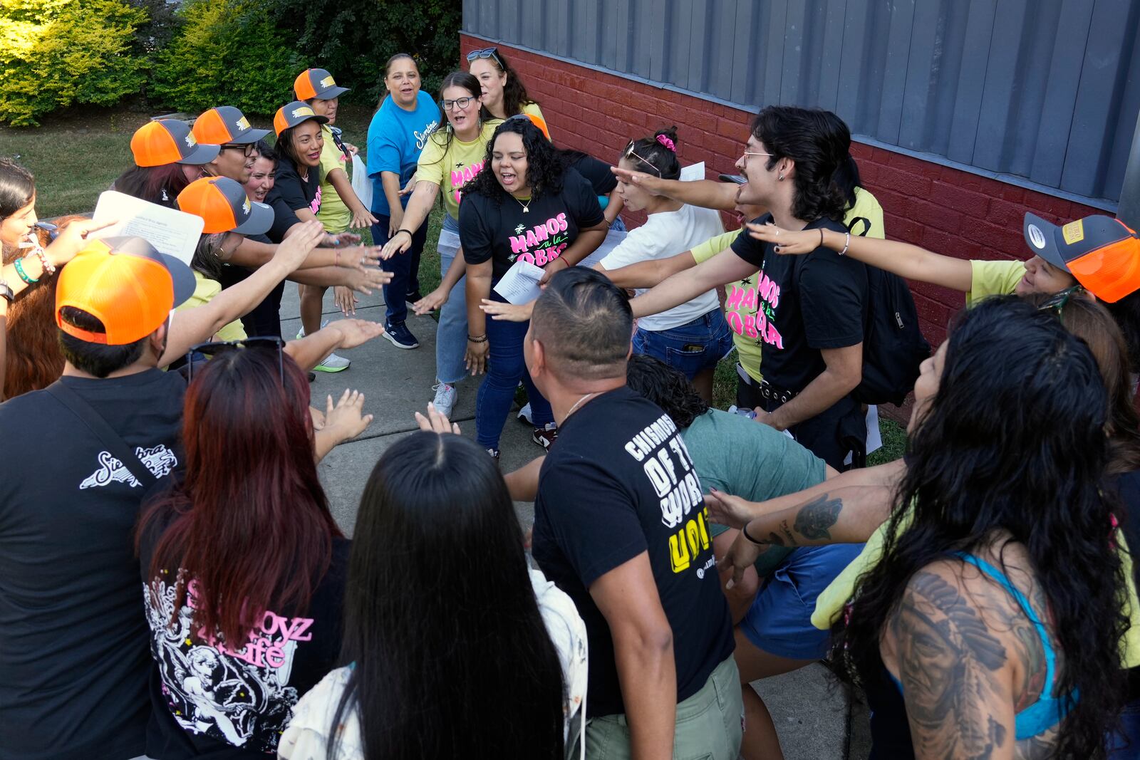 Members of a Latino support group celebrate as they meet together during a voter engagement event for the Latino community in Greensboro, N.C., Saturday, Sept. 21, 2024. (AP Photo/Chuck Burton)