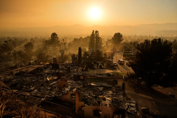 An emergency vehicle drives through a neighborhood devastated by the Eaton Fire, Thursday, Jan. 9, 2025, in Altadena, Calif. (AP Photo/John Locher)