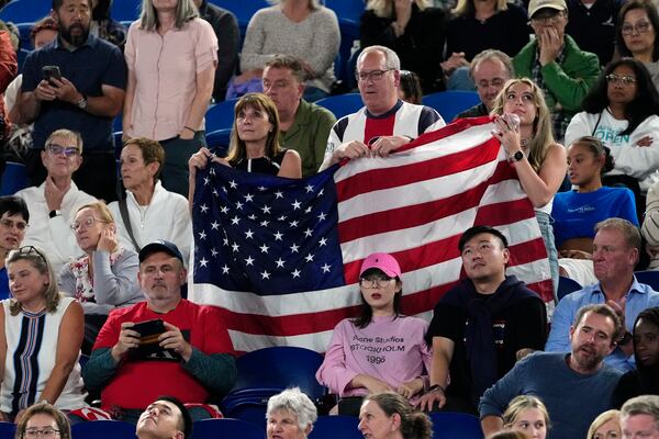 Supporters of Madison Keys of the U.S. react during her semifinal match against Iga Swiatek of Poland at the Australian Open tennis championship in Melbourne, Australia, Thursday, Jan. 23, 2025. (AP Photo/Vincent Thian)