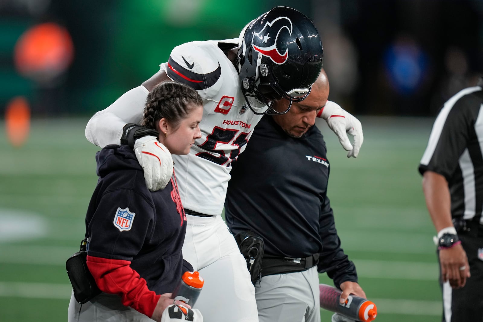 Houston Texans defensive end Will Anderson Jr. (51) is helped off the field after an injury during the first half an NFL football game against the New York Jets, Thursday, Oct. 31, 2024, in East Rutherford, N.J. (AP Photo/Seth Wenig)