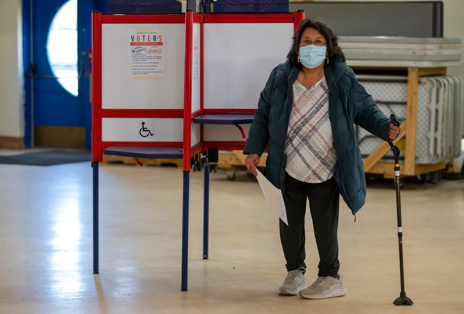 A voter looks for the tabulation machine after marking her ballot at a polling station on the Navajo Nation in Fort Defiance, Ariz., on Election Day, Tuesday, Nov. 5, 2024. (AP Photo/Andres Leighton)