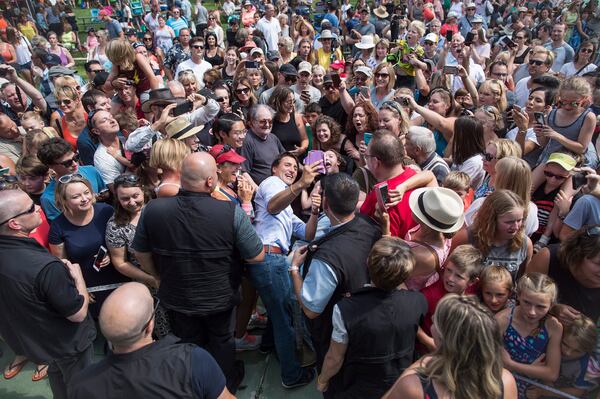 FILE - Prime Minister Justin Trudeau, centre left, takes a selfie with a person in a wheelchair during a visit to B.C. Day celebrations in Penticton, B.C., on Aug. 6, 2018. (Darryl Dyck/The Canadian Press via AP, File)