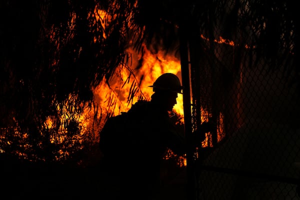 Firefighters look out over the Kenneth Fire, Thursday, Jan. 9, 2025, in the West Hills section of Los Angeles. (AP Photo/Eric Thayer)