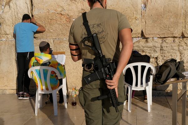 A member of the Israeli security forces prays at the Western Wall in Jerusalem's Old City, Tuesday, Dec. 3, 2024. (AP Photo/Matias Delacroix)