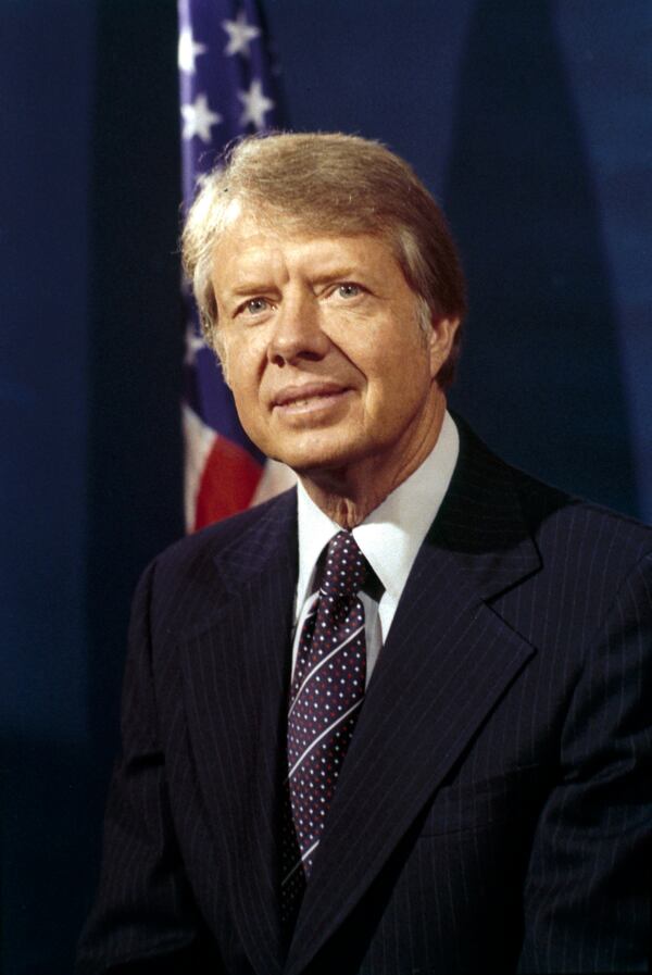 FILE - President-elect Jimmy Carter poses for photographers after sitting for his official portrait at his home in Plains, Ga., Dec. 5, 1976. (AP Photo, File)