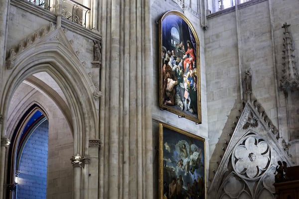 Paintings are seen inside Notre-Dame de Paris cathedral while French President Emmanuel Macron visits the restored interiors of the monument, Friday Nov. 29, 2024, in Paris. (Stephane de Sakutin, Pool via AP)