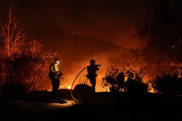 Firefighters battle the Franklin Fire in Malibu, Calif., Tuesday, Dec. 10, 2024. (AP Photo/Jae C. Hong)