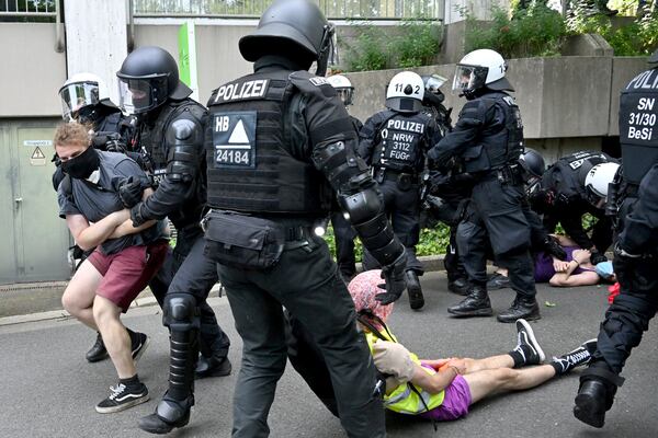 The police break up a sit-in blockade not far from the Grugahalle, in Essen, Germany, Saturday, June 29, 2024. The two-day national party conference of the AfD is taking place in the Grugahalle, including the election of the federal executive committee. Numerous organizations have announced opposition to the meeting and more than a dozen counter-demonstrations. (Henning Kaiser/dpa via AP)