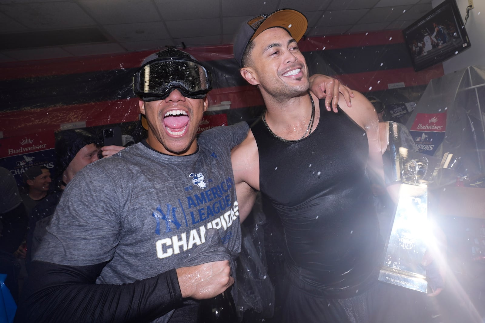 New York Yankees' Juan Soto, left, and Giancarlo Stanton celebrate after Game 5 of the baseball AL Championship Series against the Cleveland Guardians Sunday, Oct. 20, 2024, in Cleveland. The Yankees won 5-2 to advance to the World Series. (AP Photo/Godofredo A. Vásquez )