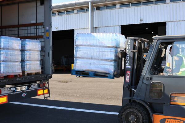 This photo provided by the French Army shows pallets of bottles of water being unloaded in the Indian Ocean French territory of Mayotte, Wednesday Dec.18, 2024, as the cyclone on Saturday was the deadliest storm to strike the territory in nearly a century. (D Piatacrrea, Etat Major des Armees/Legion Etrangere via AP)