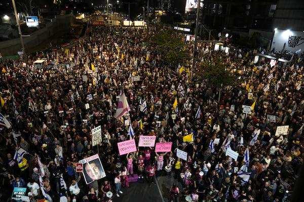 People gather to protest against Prime Minister Benjamin Netanyahu's government and call for the release of hostages held in the Gaza Strip by the Hamas militant group, in Tel Aviv, Israel, Saturday, Nov. 23, 2024. (AP Photo/Maya Alleruzzo)