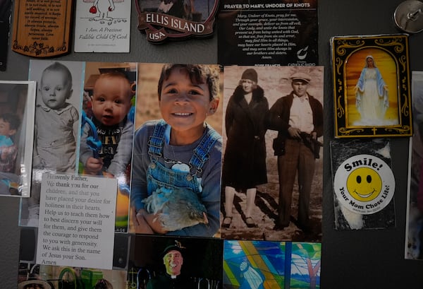 The refrigerator is decorated with family photos, prayers, and drawings in the Young's Sunbury, Ohio, kitchen on Tuesday, Nov. 12, 2024. (AP Photo/Carolyn Kaster)