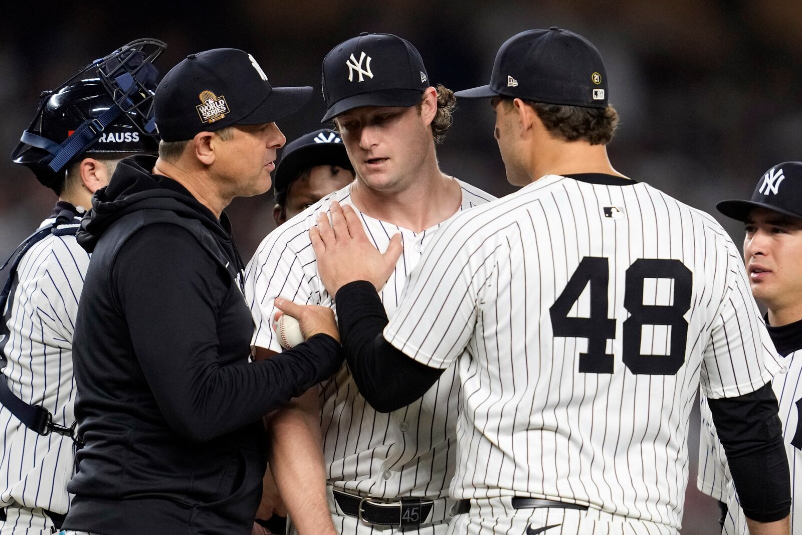 New York Yankees starting pitcher Gerrit Cole, center, is pulled by manager Aaron Boone, left, as first baseman Anthony Rizzo (48) puts his hand on the Cole's shoulder during the seventh inning in Game 5 of the baseball World Series against the Los Angeles Dodgers, Wednesday, Oct. 30, 2024, in New York. (AP Photo/Godofredo A. Vásquez)