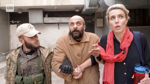 This image taken from video provided by CNN shows reporter Clarissa Ward and a man who was freed after she and a Syrian rebel guard discovered him locked in a Damascus prison. It was featured in a story that ran in early December 2024, but CNN has since discovered that the prisoner had lied about his identity. (CNN via AP)