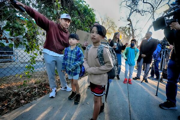 Palisades Charter Elementary School students and their parents arrive at their new school, the Brentwood Elementary Science Magnet school in the Brentwood section of Los Angeles on Wednesday, Jan. 15, 2025. (AP Photo/Richard Vogel)