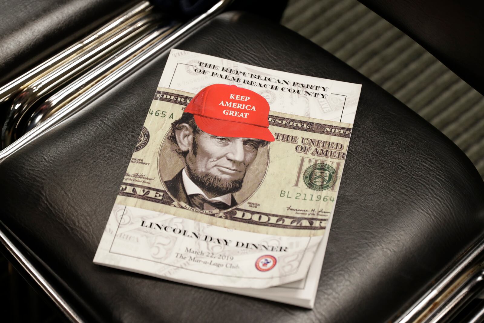 FILE - A program for a March 2019 Lincoln Day dinner held in Florida sits on a chair as President Donald Trump speaks, Nov. 8, 2019, in Atlanta. (AP Photo/ Evan Vucci, File)