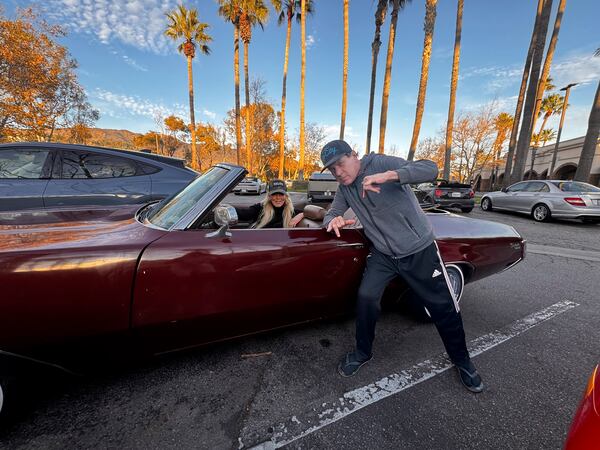 This photo courtesy of Gavin Koppel shows Randy Miod, right, and Tracy Park posing in front of Koppel's 1972 Buick Skylark custom convertible in Malibu, Jan. 5, 2025. Miod died in the Palisades fire during California's deadly wildfires in January 2025. (Gavin Koppel via AP)