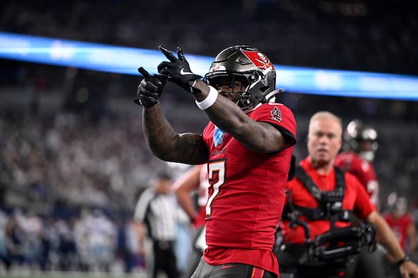 Tampa Bay Buccaneers running back Bucky Irving celebrates after rushing for a touchdown against th eDallas Cowboys in the first half of an NFL football game in Arlington, Texas, Sunday, Dec. 22, 2024. (AP Photo/Jerome Miron)