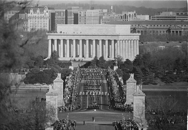 FILE - The funeral procession for the late President John Fitzgerald Kennedy, the nation's youngest president struck down by an assassin's bullets, crossed the bridge leading to Arlington National Cemetery in Arlington, Va., Nov. 25, 1963. The procession slowly moves over the Memorial Bridge, with Lincoln memorial in background, monument to another slain president. (AP Photo, File)