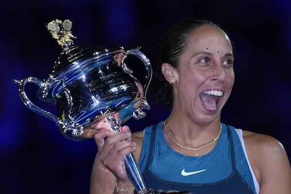 Madison Keys of the U.S. reacts as she receives the the Daphne Akhurst Memorial Cup from Evonne Goolagong Cawley after defeating Aryna Sabalenka of Belarus in the women's singles final at the Australian Open tennis championship in Melbourne, Australia, Saturday, Jan. 25, 2025. (AP Photo/Ng Han Guan)