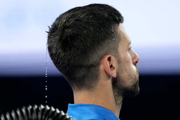 Water drips from the head of Novak Djokovic of Serbia during his fourth round match against Jiri Lehecka of the Czech Republic at the Australian Open tennis championship in Melbourne, Australia, Sunday, Jan. 19, 2025. (AP Photo/Mark Baker)