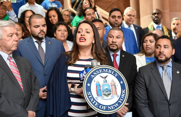 FILE - Asemblywoman Catalina Cruz, D- Jackson Heights, center, speaks in favor of legislation for the Green Light Bill granting undocumented Immigrant driver's licenses during a rally at the state Capitol Monday, June 17, 2019, in Albany, N.Y. (AP Photo/Hans Pennink, File)