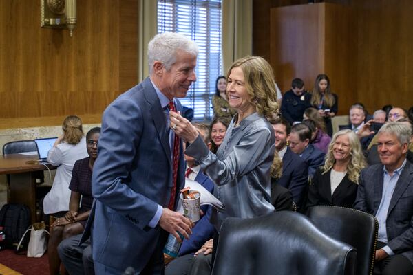 Chris Wright, President-elect Donald Trump's nominee to be Secretary of Energy, left, has his tie adjusted by his wife Liz Wright as he arrives for Senate Committee on Energy and Natural Resources hearing for his pending confirmation, on Capitol Hill, Wednesday, Jan. 15, 2025, in Washington. (AP Photo/Rod Lamkey, Jr.)