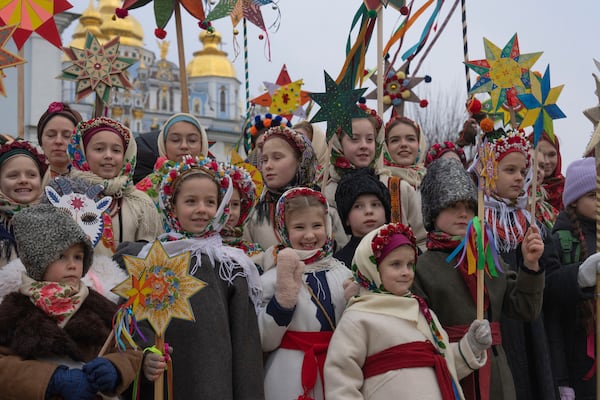 Children wearing national suits celebrate Christmas near St. Michael Monastery in a city centre in Kyiv, Ukraine, Wednesday, Dec. 25, 2024. (AP Photo/Efrem Lukatsky)