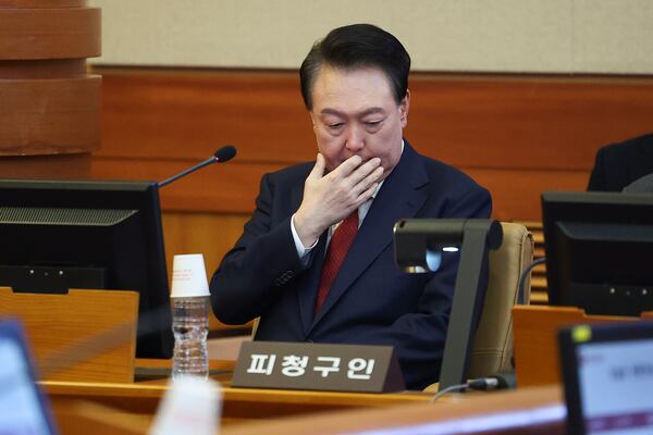 Impeached South Korean President Yoon Suk Yeol, left, sits at his impeachment trial at the Constitutional Court in Seoul, South Korea, Tuesday, Jan. 21, 2025. (Kim Hong-Ji/Pool Photo via AP)