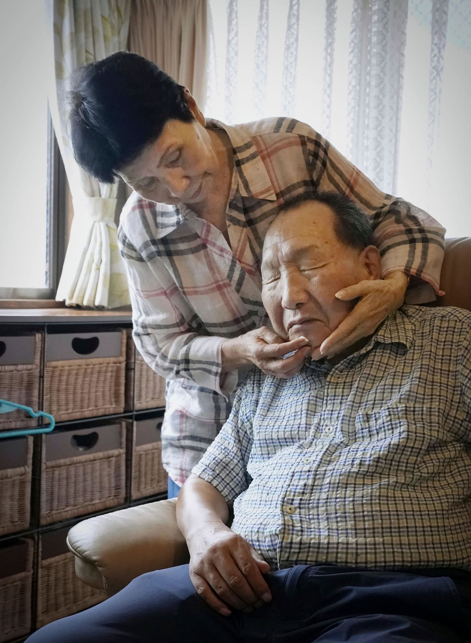 Hideko Hakamada, left, sister of former boxer Iwao Hakamada who has been on death row for a 1966 quadruple murder case, puts moisturizer on her brother's face after shaving, in Hamamatsu, Shizuoka prefecture, central Japan, on Aug. 20, 2021. Japanese prosecutors said on Oct. 8, 2024 they will not appeal the Sept. 26 ruling of the Shizuoka District Court that acquitted the world’s longest-serving death-row inmate in a retrial. (Kyodo News via AP)