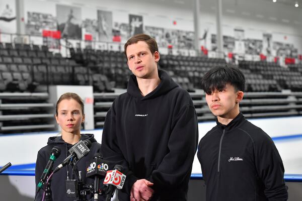 American figure skaters, from the left, Alisa Efimova, Misha Mitrofanov, and Jimmy Ma, speak to members of the media at the The Skating Club of Boston, where several athletes, coaches and family associated with the club are believed to have perished in the collision of a passenger aircraft and military helicopter in Washington, Thursday, Jan. 30, 2025, in Norwood, Mass. (AP Photo/Steven Senne)