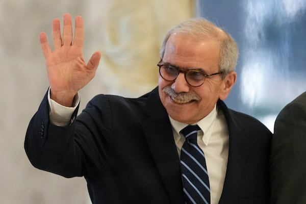 Lebanese Prime Minister-designate Nawaf Salam waves to journalists as he arrives at the presidential palace to meet with Lebanese President Joseph Aoun in Baabda, in east of Beirut, Lebanon, Tuesday, Jan. 14, 2025. (AP Photo/Hassan Ammar)