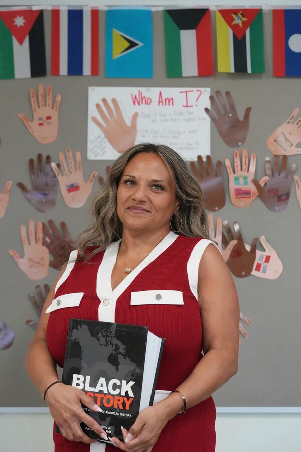 Renee O'Connor stands in one of the classrooms where she teaches Black history at Miami Norland Senior High School, Thursday, Dec. 19, 2024, in Miami Gardens, Fla. (AP Photo/Marta Lavandier)