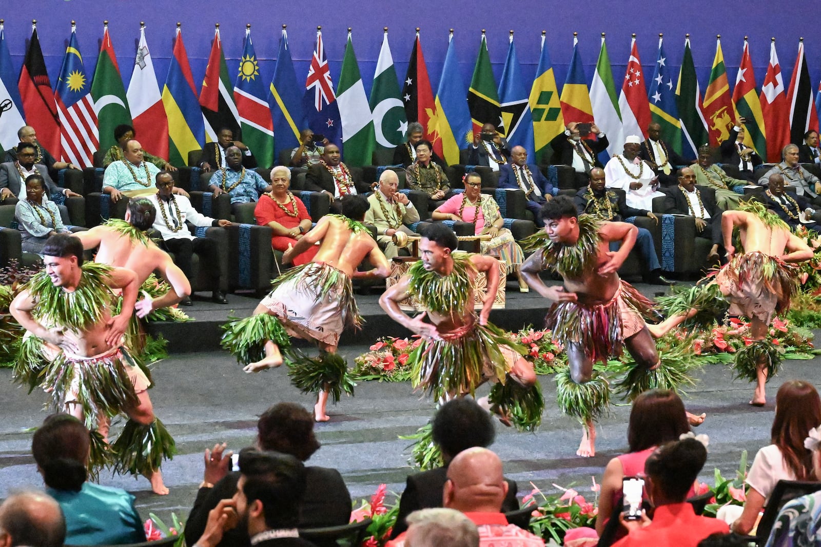 Britain's King Charles III, center, watches as dancers perform during the opening ceremony for the Commonwealth Heads of Government Meeting (CHOGM) in Apia, Samoa, on Friday, Oct. 25, 2024. (AP Photo/William West, Pool)