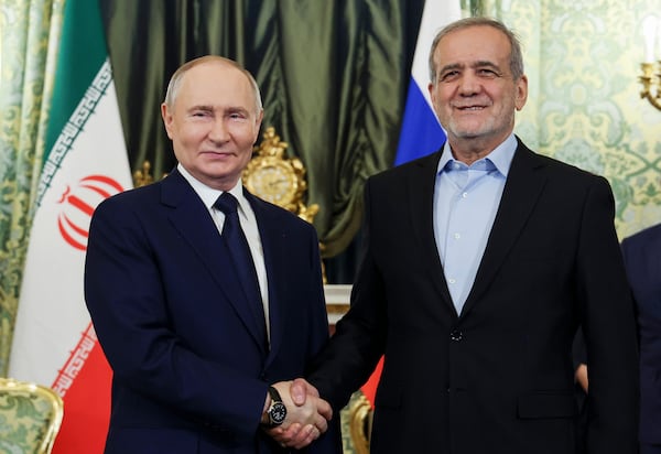 Russian President Vladimir Putin, left, and Iranian President Masoud Pezeshkian pose for a photo during their meeting at the Kremlin in Moscow, Russia, Friday, Jan. 17, 2025. (Vyacheslav Prokofyev, Sputnik, Kremlin Pool Photo via AP)