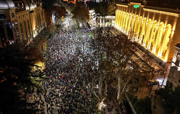 Protesters pour into the streets following Georgian Prime Minister Irakli Kobakhidze's announcement, rallying outside the parliament building in Tbilisi, Georgia, on Thursday, Nov. 28, 2024. (AP Photo/Zurab Tsertsvadze)