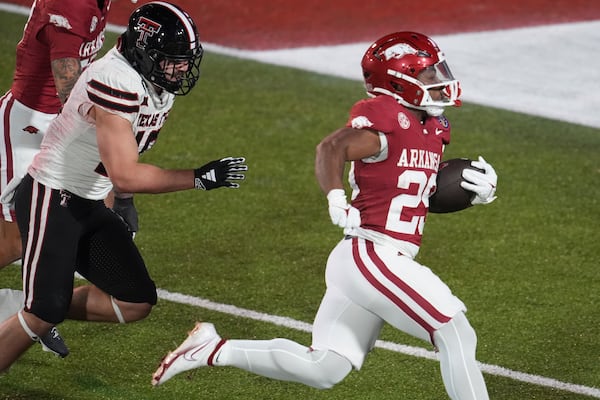 Arkansas running back Tyrell Reed Jr., right, scores a touchdown during the second half of the Liberty Bowl NCAA college football game against Texas Tech, Friday, Dec. 27, 2024, in Memphis, Tenn. (AP Photo/George Walker IV)