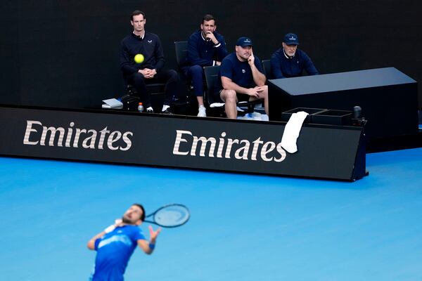 Andy Murray, top left, coach of Novak Djokovic of Serbia watches his first round match against Nishesh Basavareddy of the U.S. at the Australian Open tennis championship in Melbourne, Australia, Monday, Jan. 13, 2025. (AP Photo/Asanka Brendon Ratnayake)