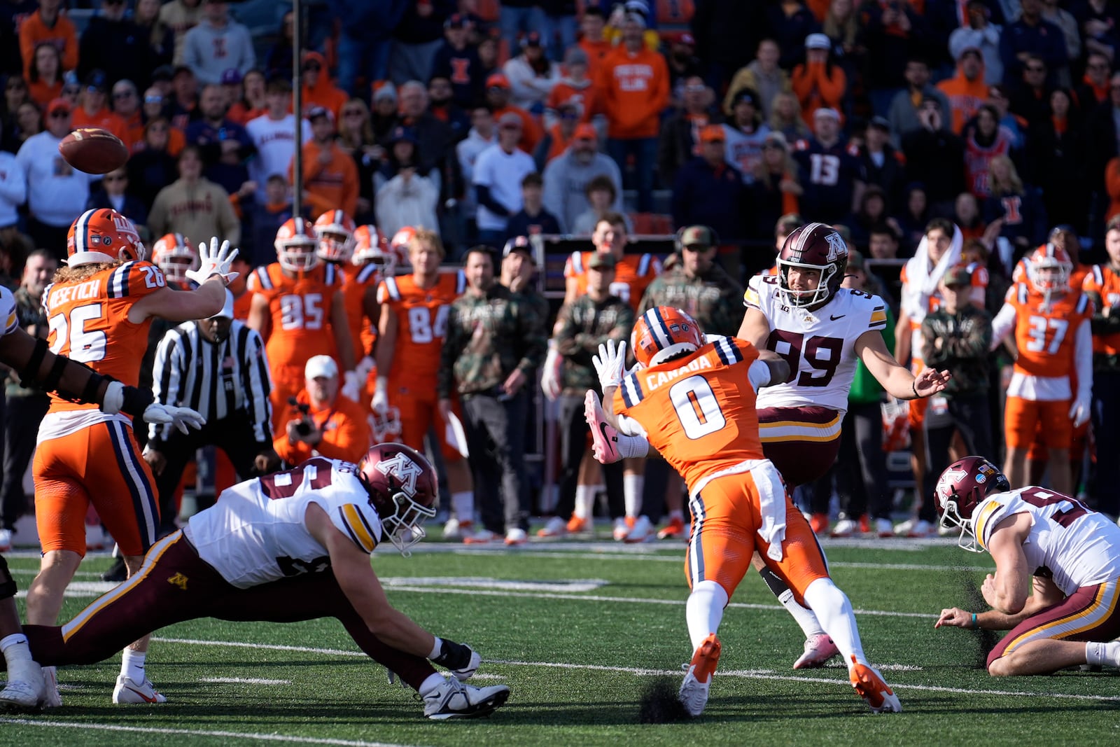 Minnesota place kicker Dragan Kesich (99) kicks a field goal during the second half of an NCAA college football game against Illinois on Saturday, Nov. 2, 2024, in Champaign, Ill. (AP Photo/Charles Rex Arbogast)