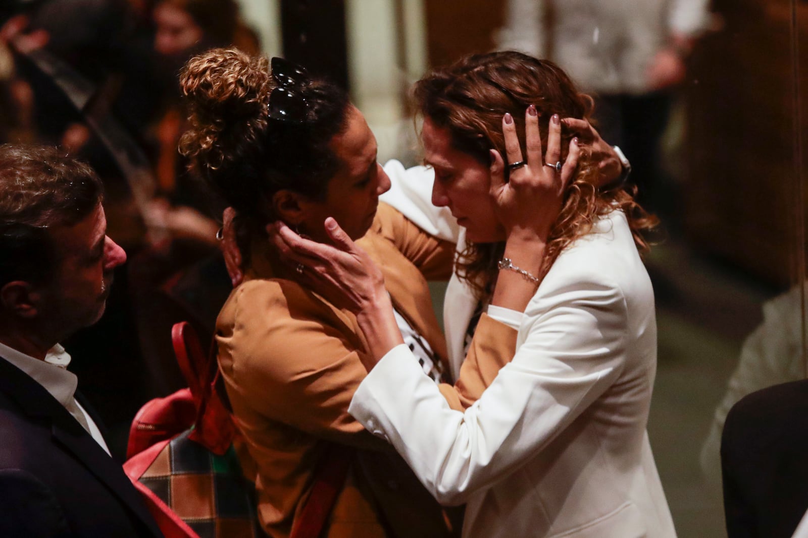 The sister, left, and widow of slain councilwoman Marielle Franco embrace after a judge sentenced two former police officers for the 2018 murder of Franco and her driver Anderson Gomes, at the Court of Justice in Rio de Janeiro, Thursday, Oct. 31, 2024. (AP Photo/Bruna Prado)