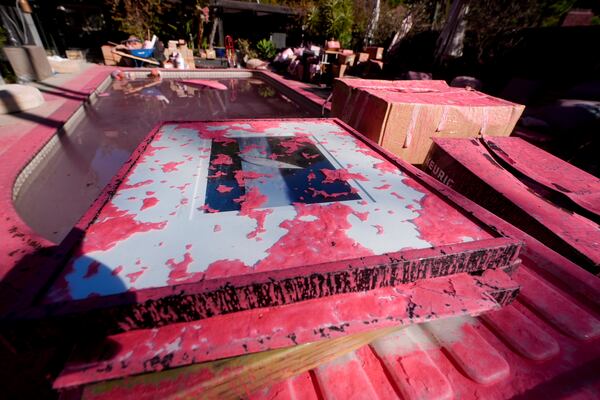 Retardant covers a framed photograph after crews battled the Palisades Fire in Mandeville Canyon Monday, Jan 13, 2025 in Los Angeles. (AP Photo/Richard Vogel)